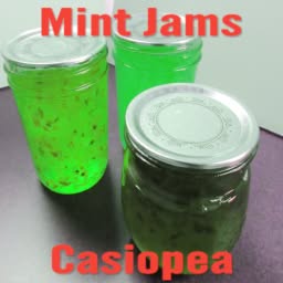 Clearly edited-looking photo of 3 jars with green jam